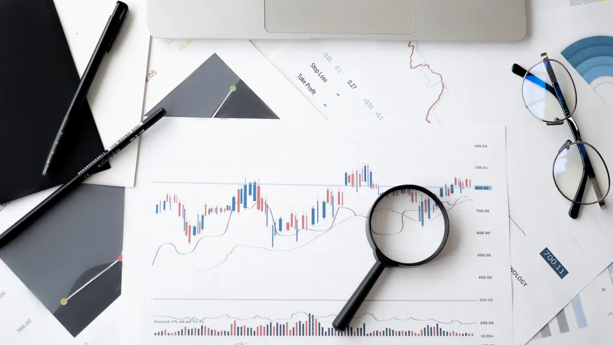 AI content writer tools with SEO features: what to look for Desk with analytics sheet, magnifying glass, and laptop