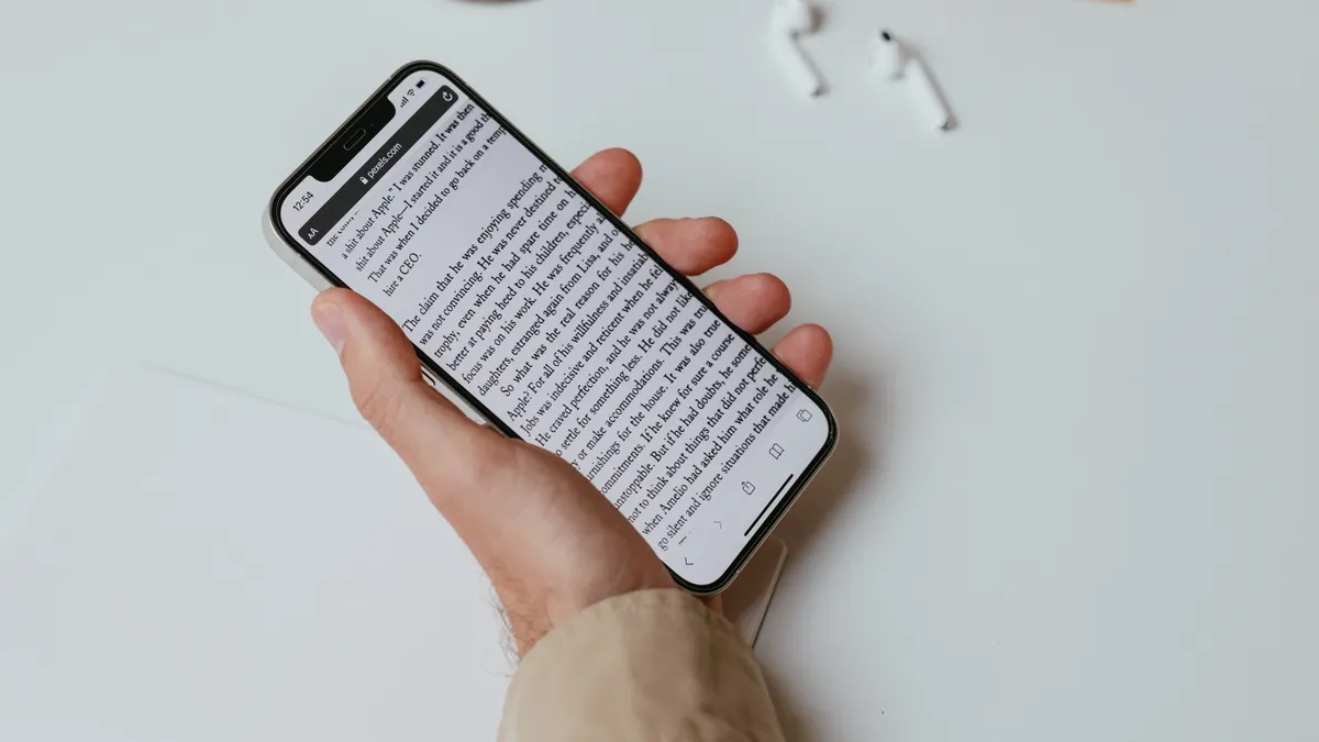 AI content writing tools for ecommerce brand voice consistency — A Person Writing While Holding a Smartphone