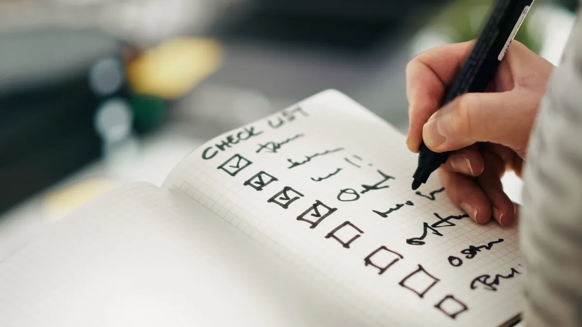 AI content writing tools: use cases and workflows — The Complete Guide — Close-up of a Hand Writing on a To-Do List