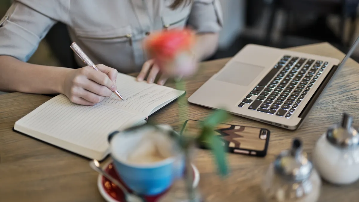 How to use AI content writer tools to draft blog posts How to use AI content writer tools to draft blog posts — Person Writing On A Notebook Beside Macbook
